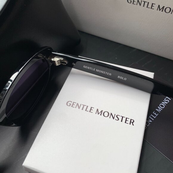 Gentle Monster Black Oval Sunglasses w/ Gold Logo – Chic & Trendy